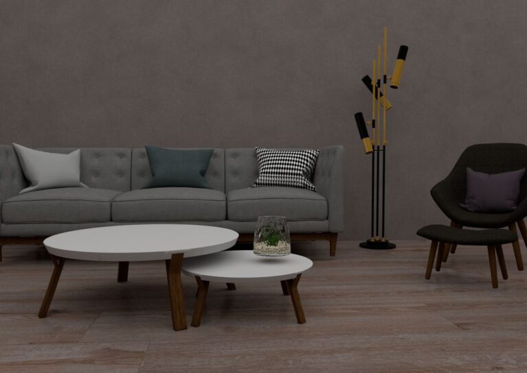 A stylish modern living room with a sofa, chairs, tables, and a unique floor lamp.