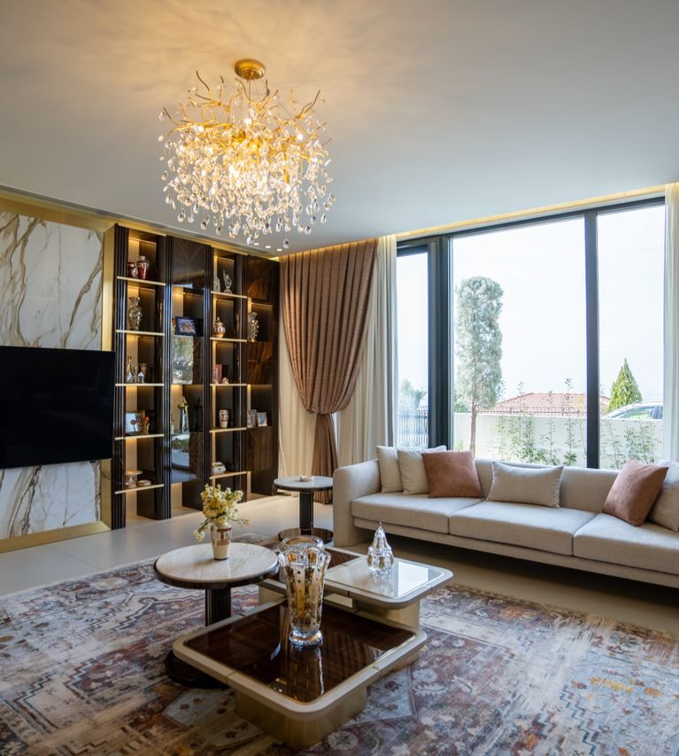 Luxurious modern living room with chandelier and large windows in Sulaymaniyah, Kurdistan.